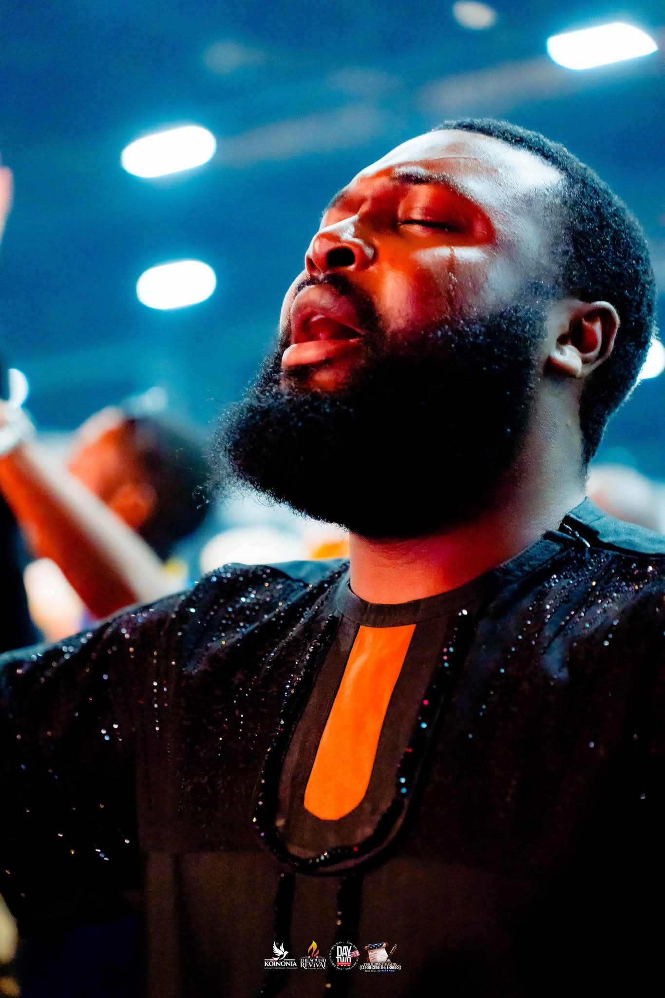 Man in tears stood in Worship