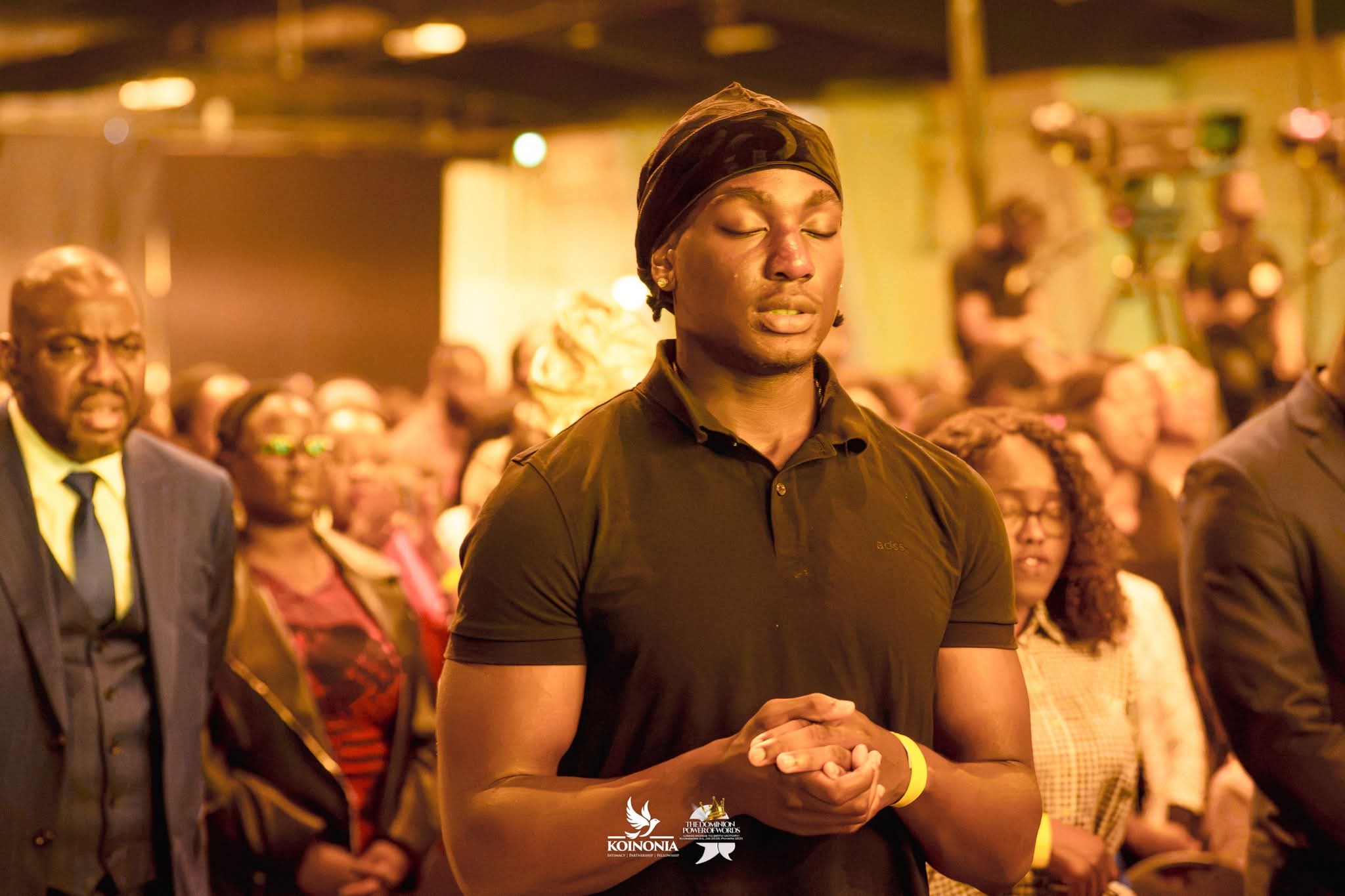Young man's  hands raised in worship