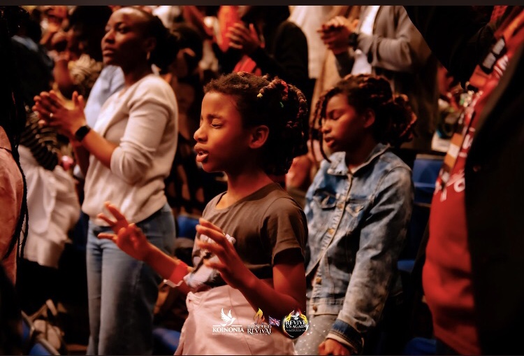 young one standing in worship